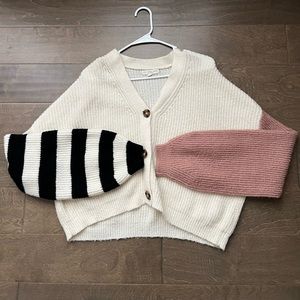 Oversized cream sweater with mismatched arm patterns